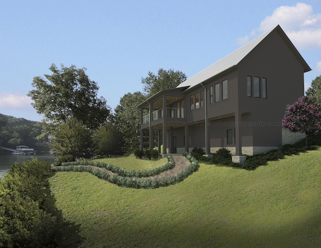 back of property featuring a water view, a lawn, and a balcony