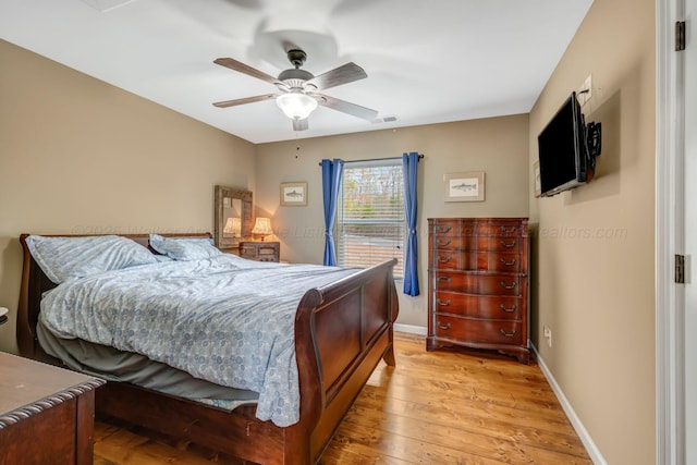 bedroom with ceiling fan and light wood-type flooring