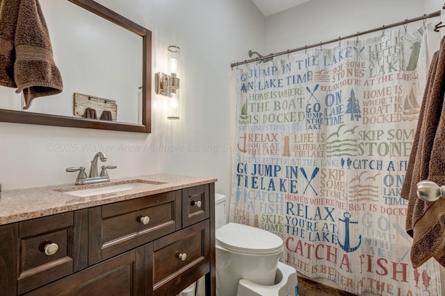 full bathroom with vanity, shower / bath combination with curtain, and toilet