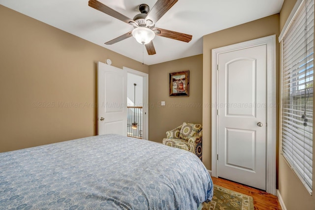 bedroom featuring hardwood / wood-style floors and ceiling fan