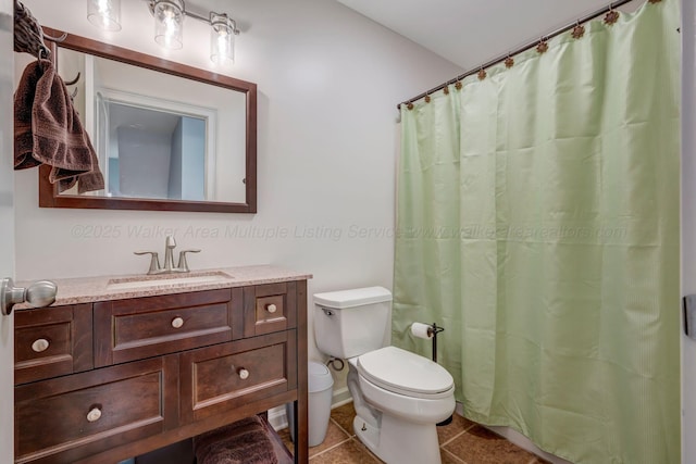 bathroom with tile patterned flooring, vanity, curtained shower, and toilet