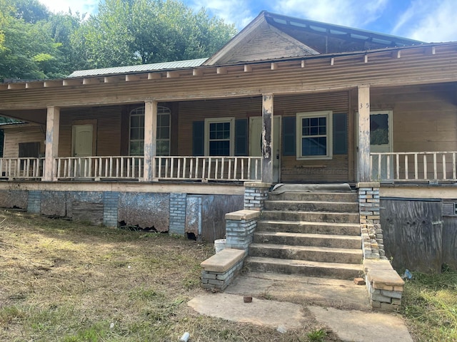 back of property with covered porch