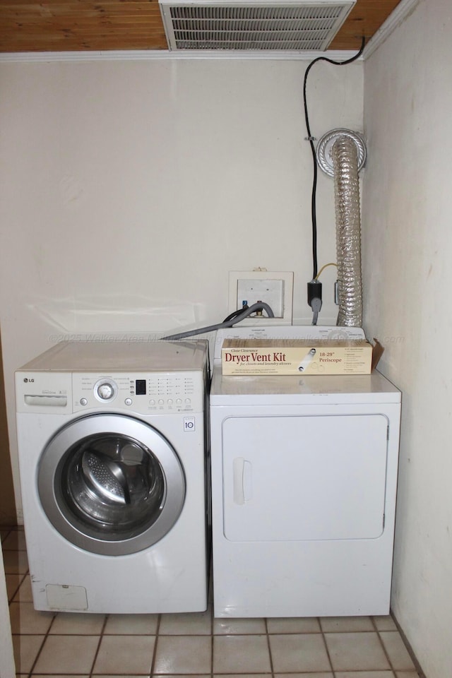 laundry room featuring light tile patterned floors, laundry area, and separate washer and dryer