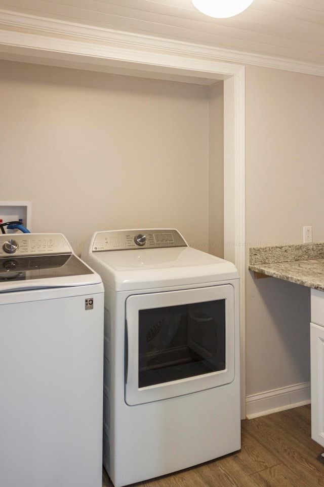 laundry area with dark hardwood / wood-style floors, independent washer and dryer, and crown molding