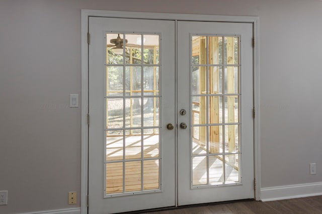 doorway with french doors and dark hardwood / wood-style flooring