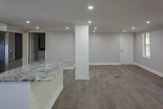 basement featuring washer / clothes dryer, stainless steel fridge with ice dispenser, wood-type flooring, and ornamental molding