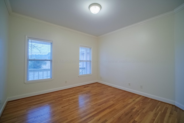 unfurnished room featuring hardwood / wood-style flooring and crown molding