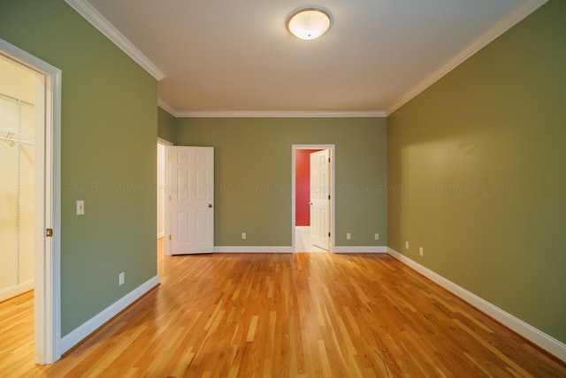 unfurnished bedroom featuring crown molding and light wood-type flooring