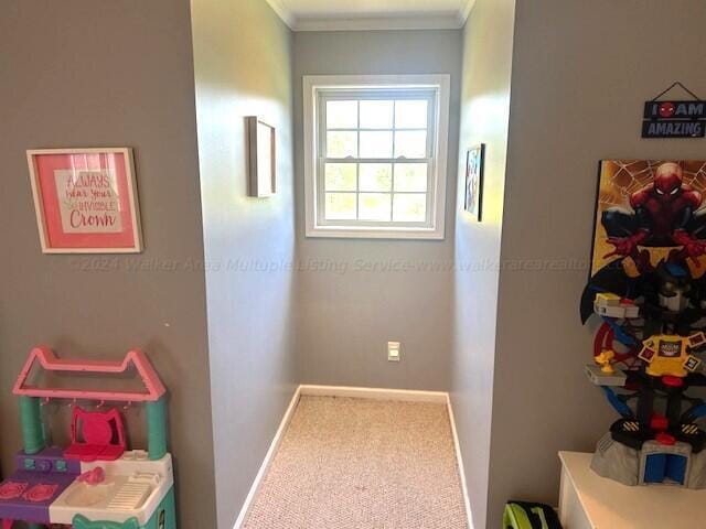 hallway with carpet and crown molding