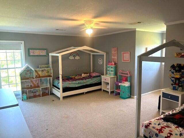 carpeted bedroom with access to outside, ceiling fan, and ornamental molding