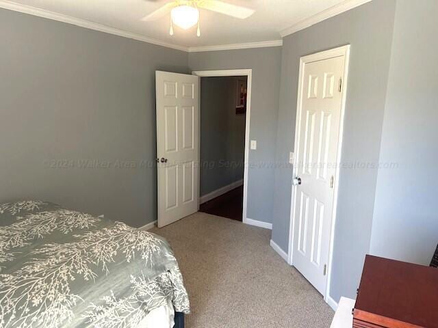 bedroom featuring carpet flooring, ceiling fan, and crown molding