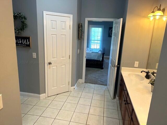 bathroom with tile patterned flooring and vanity