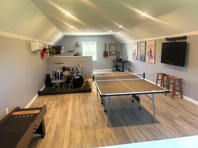 game room featuring hardwood / wood-style floors and lofted ceiling