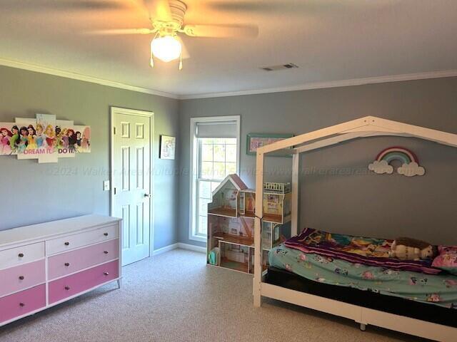 bedroom featuring carpet flooring, ceiling fan, and ornamental molding