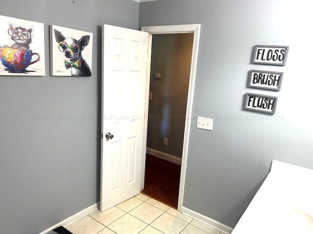 corridor featuring light tile patterned flooring