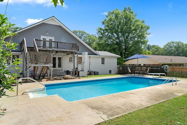 view of pool featuring french doors and a patio area