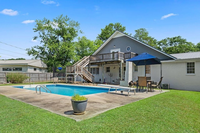 view of pool featuring a patio area, a yard, and central AC