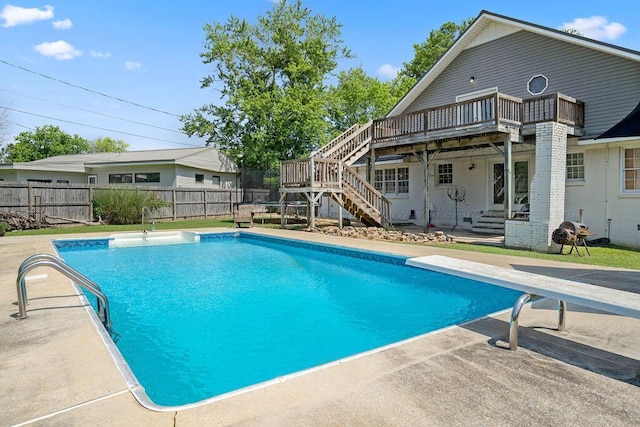 view of pool featuring a patio area and a diving board