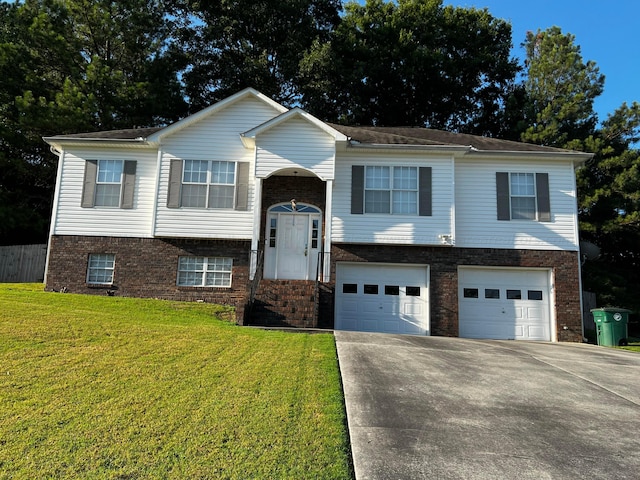 raised ranch featuring a front lawn and a garage