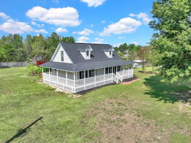 rear view of house with a porch and a yard