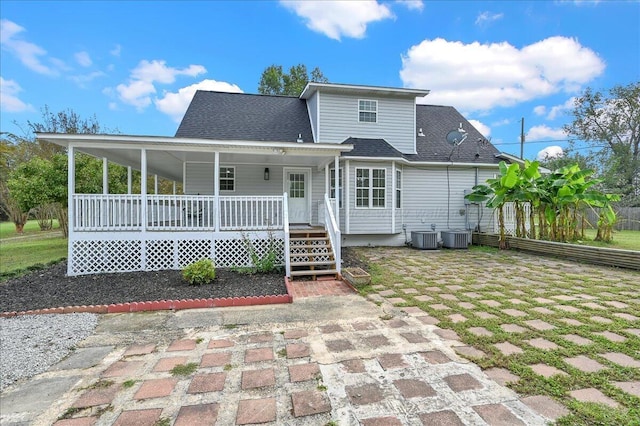 back of property featuring covered porch