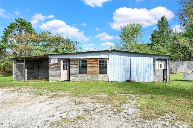 view of outbuilding featuring a lawn