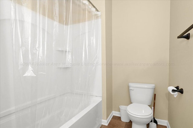 bathroom with tile patterned floors, shower / bath combo, and toilet