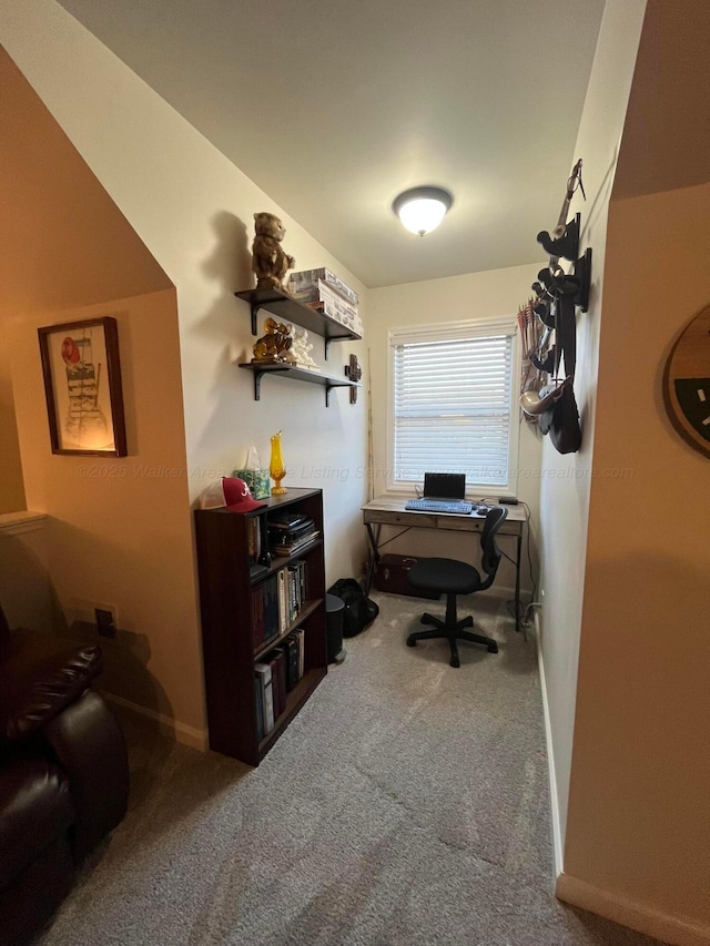 carpeted home office featuring baseboards