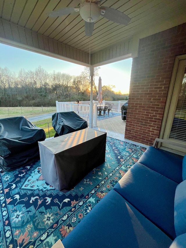 view of patio / terrace with outdoor dining area, area for grilling, fence, an outdoor living space, and a ceiling fan