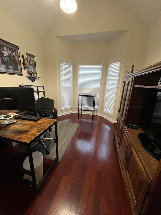 office area with dark wood-style flooring and baseboards