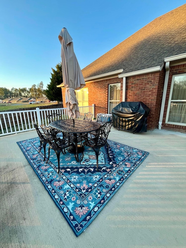 deck featuring grilling area and outdoor dining space