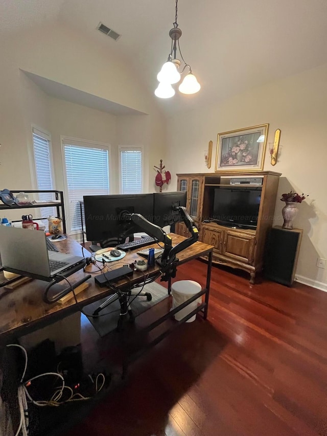 office space with baseboards, visible vents, lofted ceiling, dark wood-type flooring, and a notable chandelier