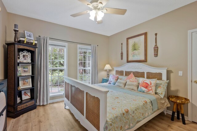 bedroom with ceiling fan and light hardwood / wood-style flooring