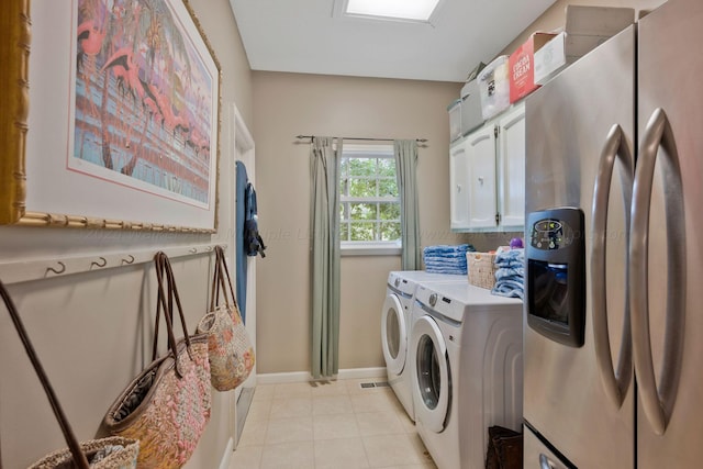 washroom with washing machine and clothes dryer and cabinets