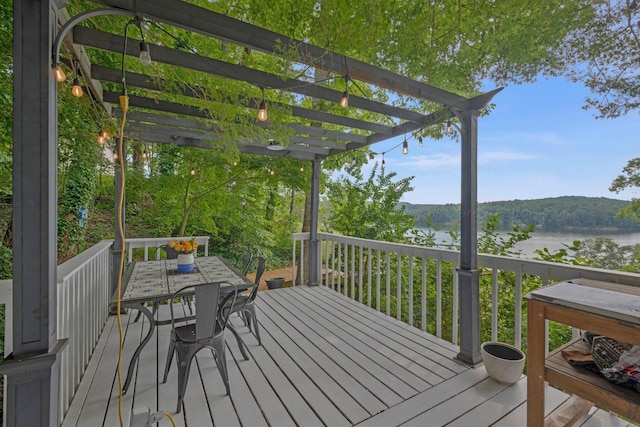 deck with a pergola and a water view