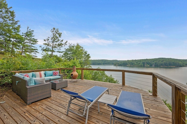 deck featuring outdoor lounge area and a water view