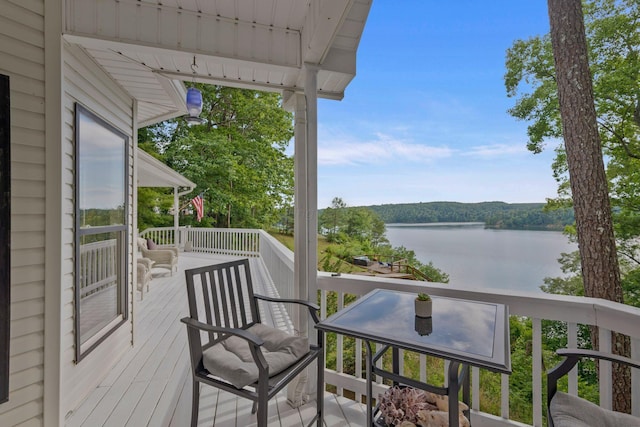 balcony featuring a deck with water view