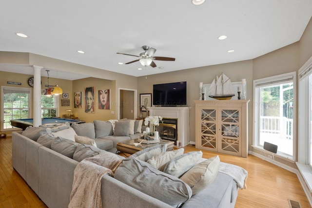 living room with ceiling fan, light wood-type flooring, and billiards