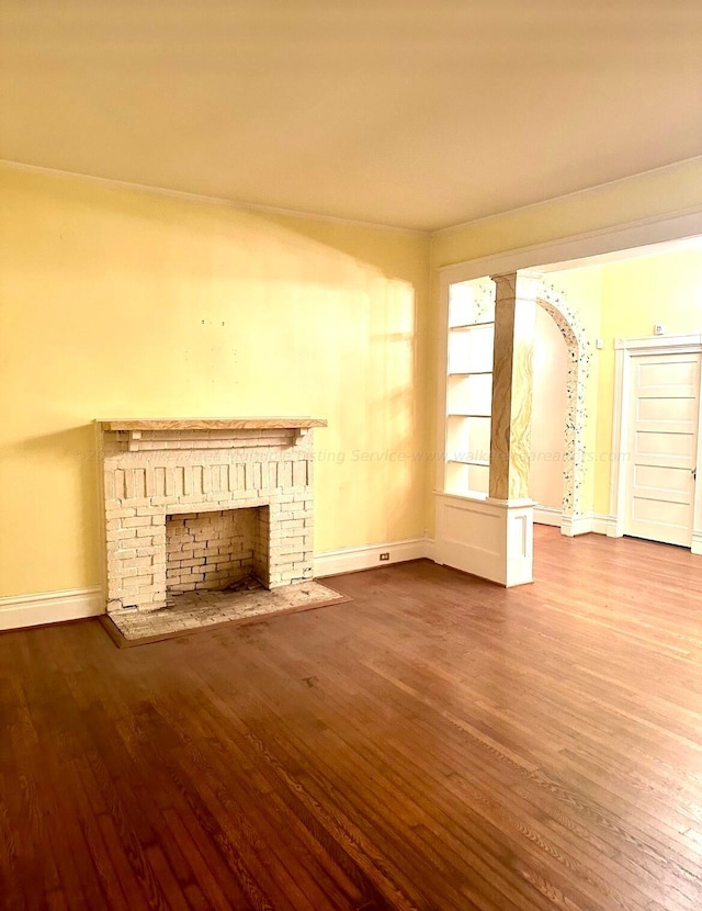 unfurnished living room featuring hardwood / wood-style floors and a fireplace