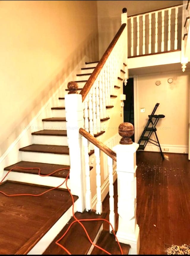 stairway featuring wood-type flooring