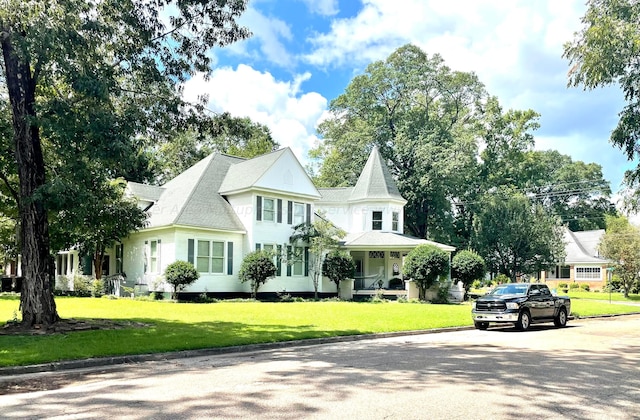 victorian-style house with a front yard