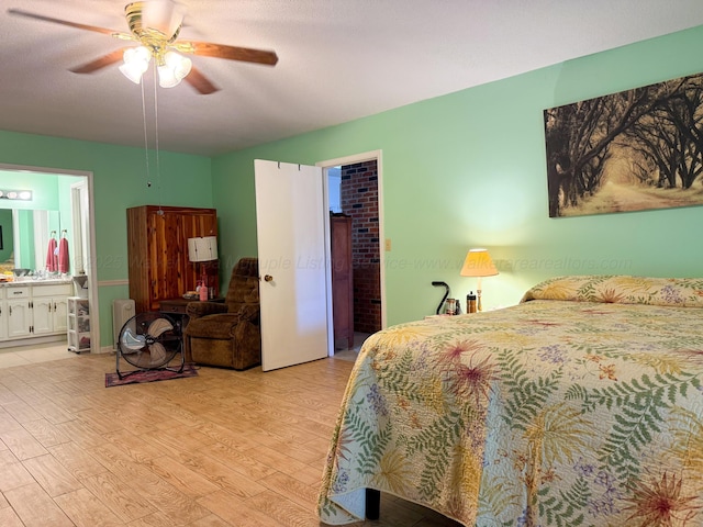 bedroom with ceiling fan, light wood-type flooring, and connected bathroom