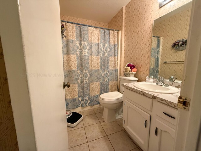 bathroom featuring vanity, a shower with shower curtain, wallpapered walls, tile patterned flooring, and toilet