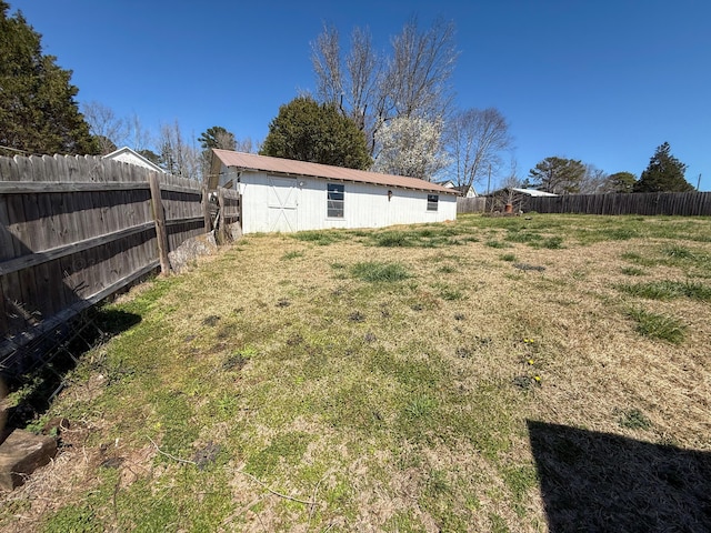 view of yard with an outbuilding and a fenced backyard