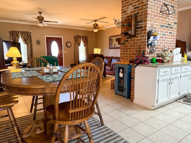 dining room featuring light tile patterned floors, a ceiling fan, and ornamental molding