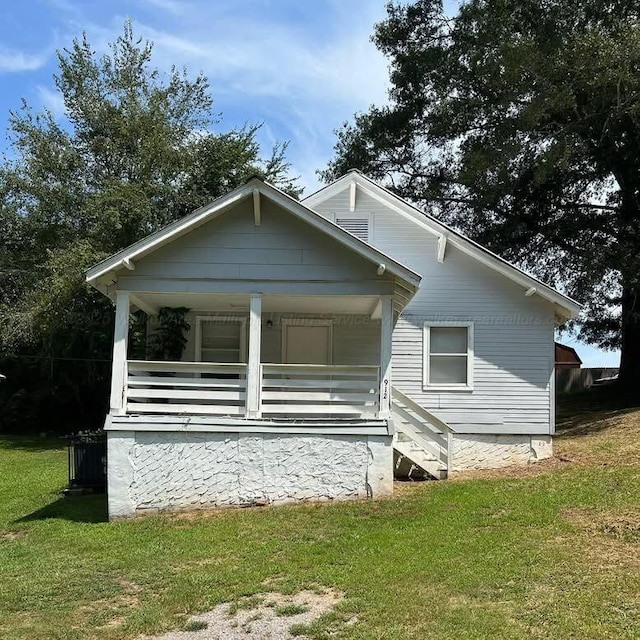 exterior space with a lawn and covered porch