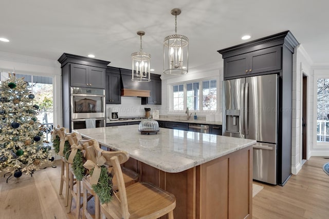 kitchen featuring a center island, stainless steel appliances, and a wealth of natural light