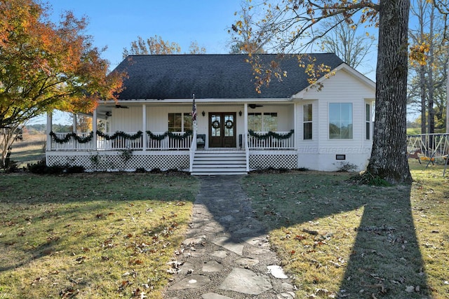 view of front of home featuring french doors, a front lawn, and covered porch