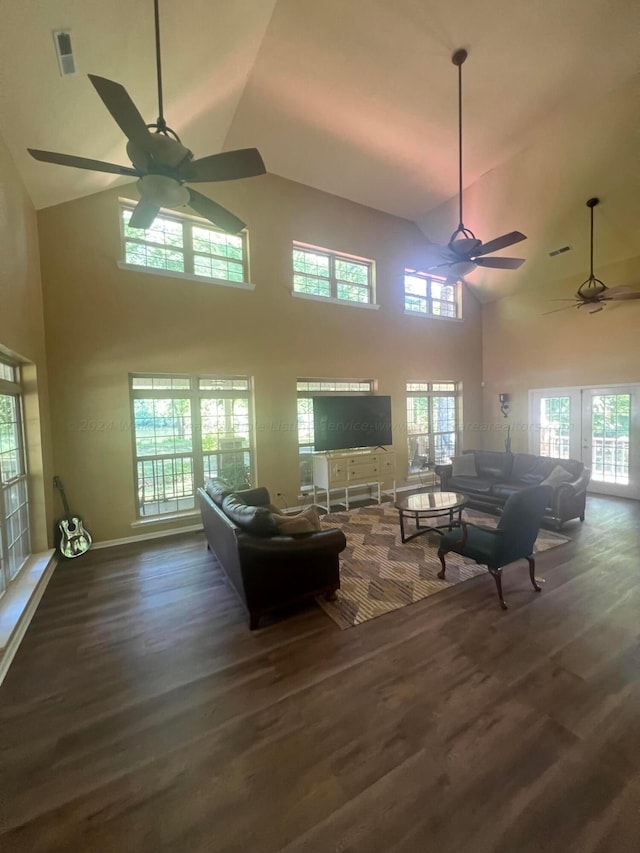 living room featuring ceiling fan, plenty of natural light, dark hardwood / wood-style floors, and high vaulted ceiling