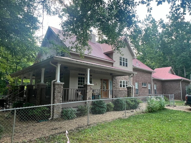 view of front of property with a porch and a front yard